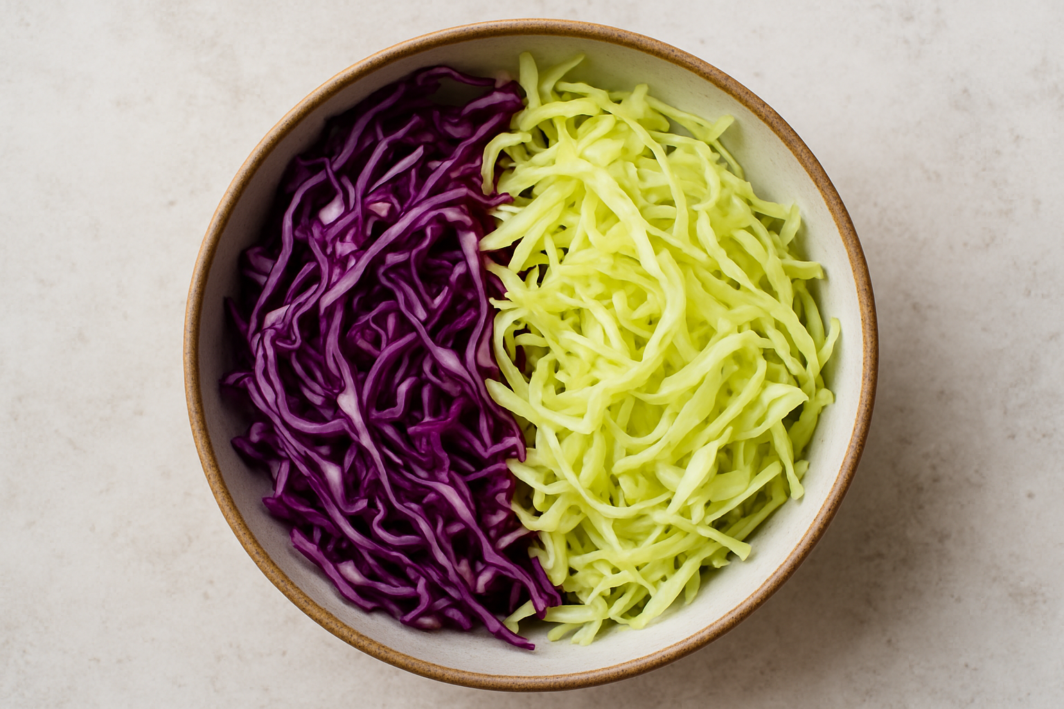 sliced red and green cabbage in a bowl